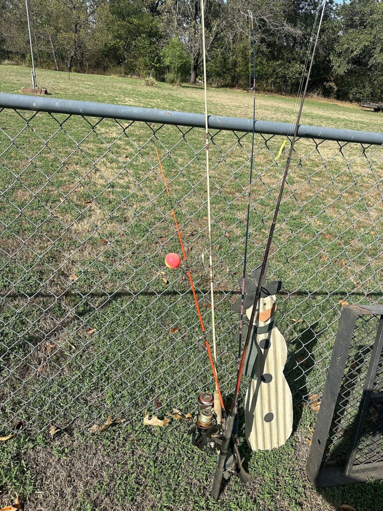 Fishing rods and reels, wood snowman yard decoration and steel mesh hitch cargo carrier