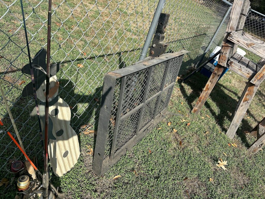 Fishing rods and reels, wood snowman yard decoration and steel mesh hitch cargo carrier