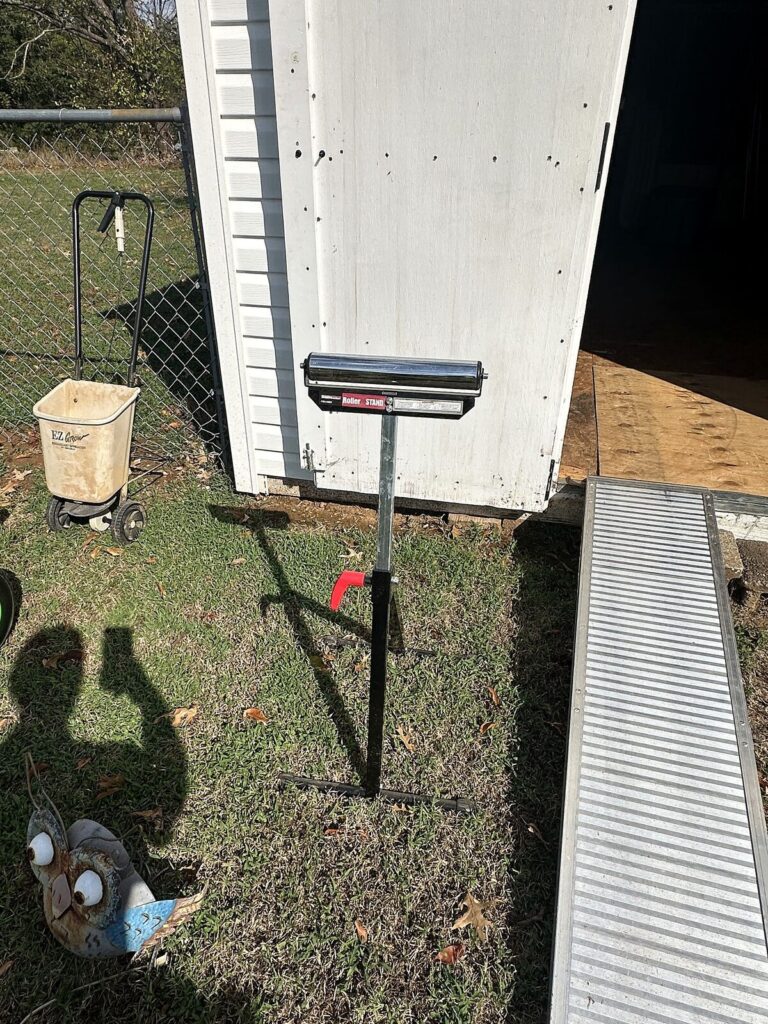 Roller stand, push spreader and metal owl yard art