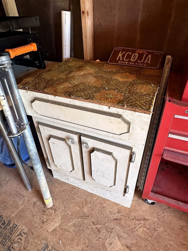 White cabinet, vintage Missouri license plate and light stand