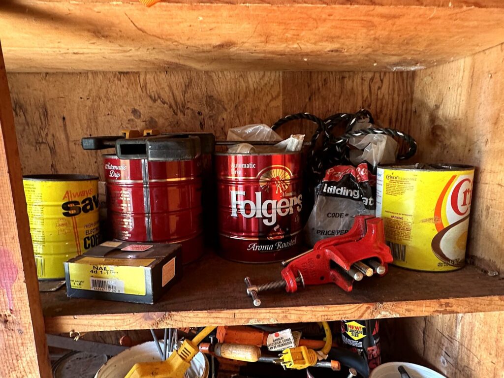 Coffee cans of hardware, box of nails, bar clamp and extension cord
