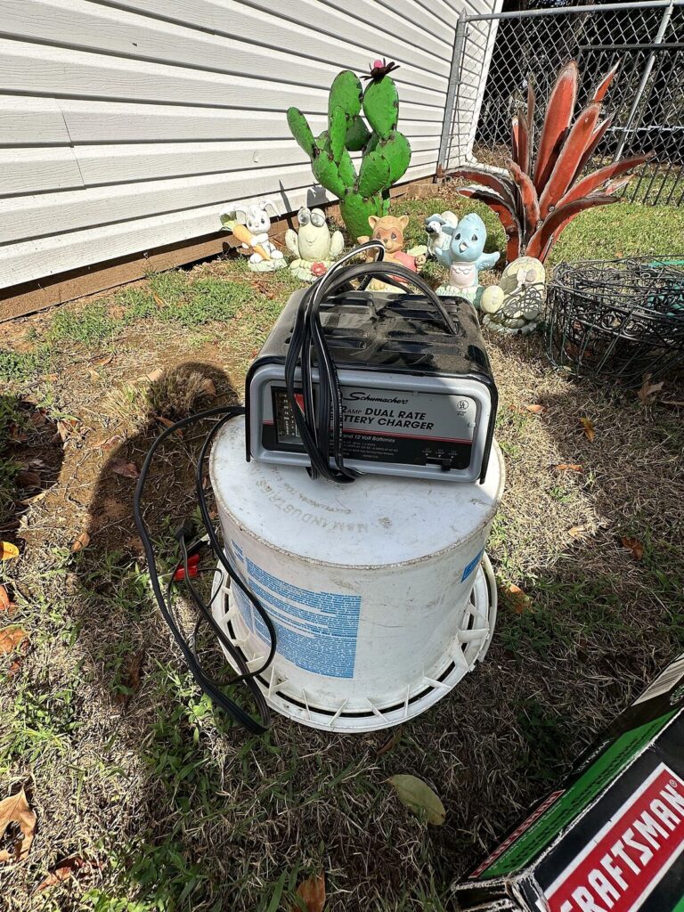 Schumacher battery charger, buckets and concrete yard animals