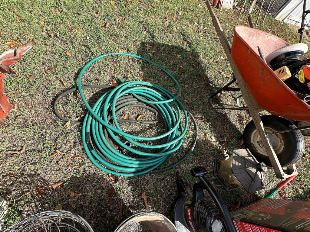 Garden hoses and wheelbarrow