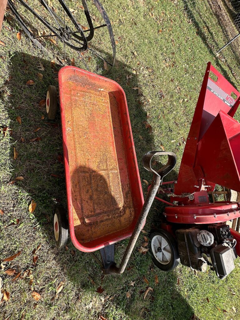Red gas chipper shredder and red metal wagon