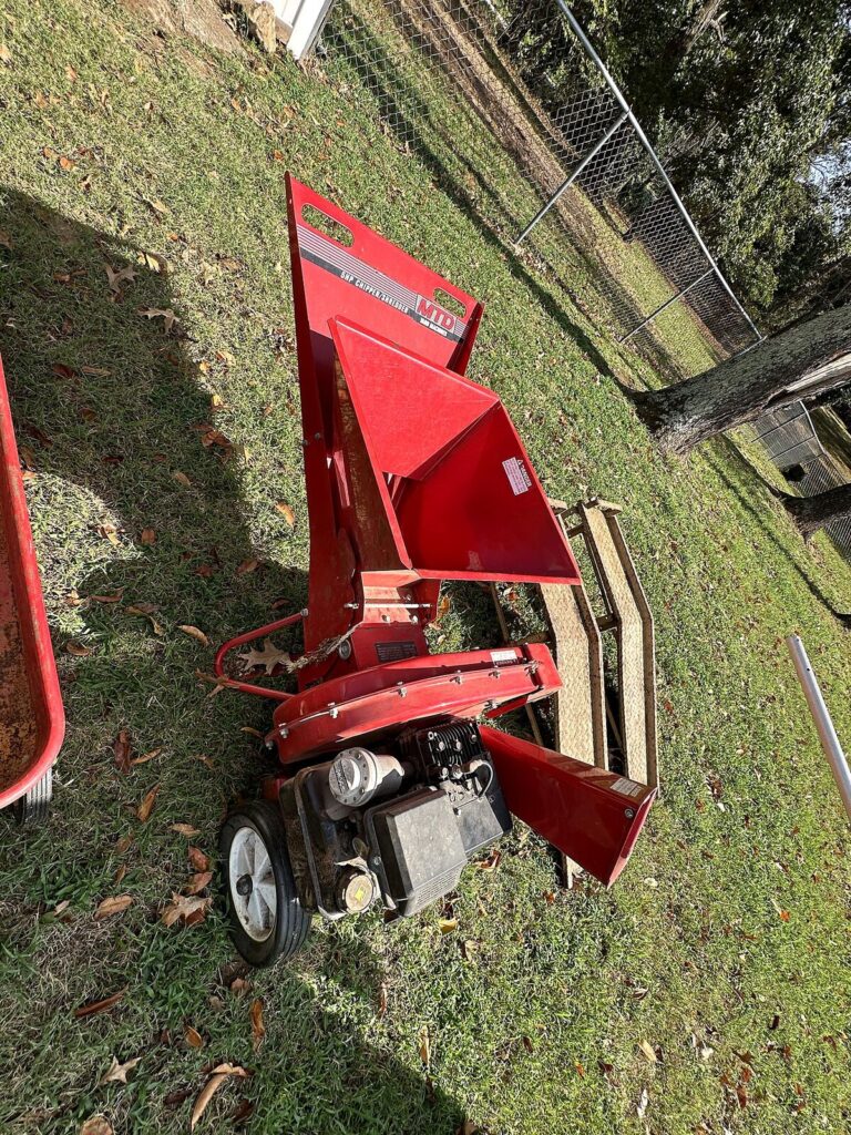 Red gas chipper shredder and red metal wagon