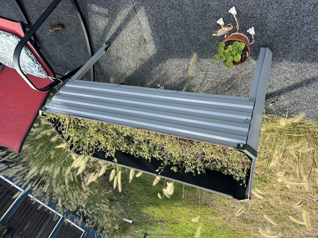 Galvanized elevated raised garden beds and red folding chair