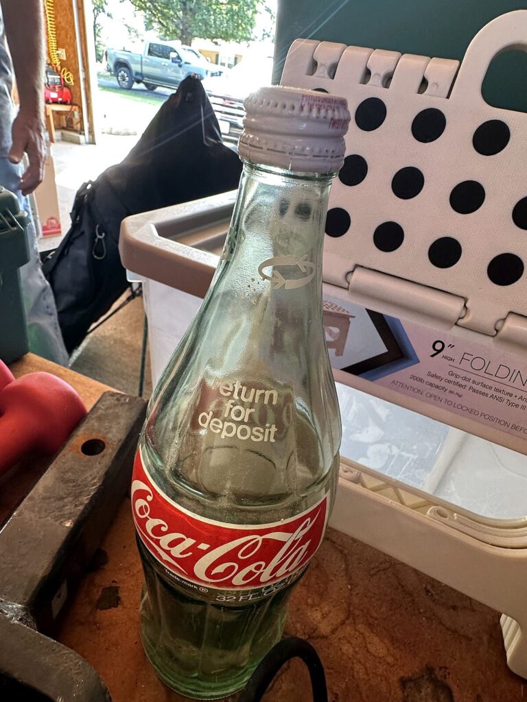 Coca-Cola 32 oz glass bottle and folding step stool