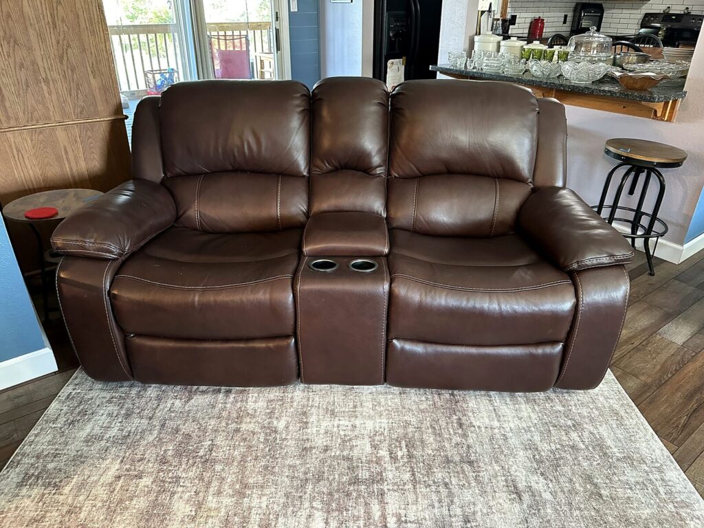 Brown leather dual reclining loveseat with console